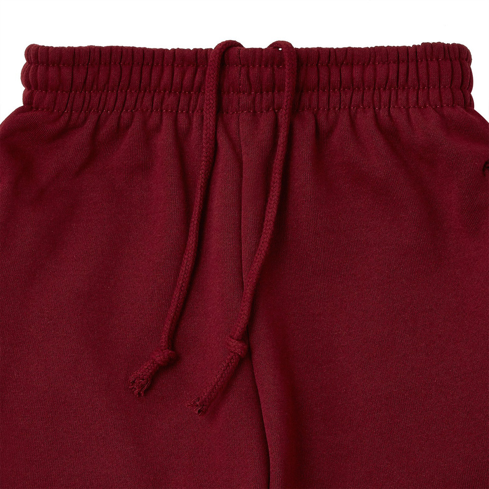 Maroon kids fleece track pants with elasticated waistband and drawstring cord, close-up packshot