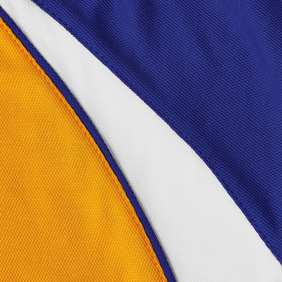 Close-up of royal blue, gold and white contrast raglan panel detail on a textured sports polo