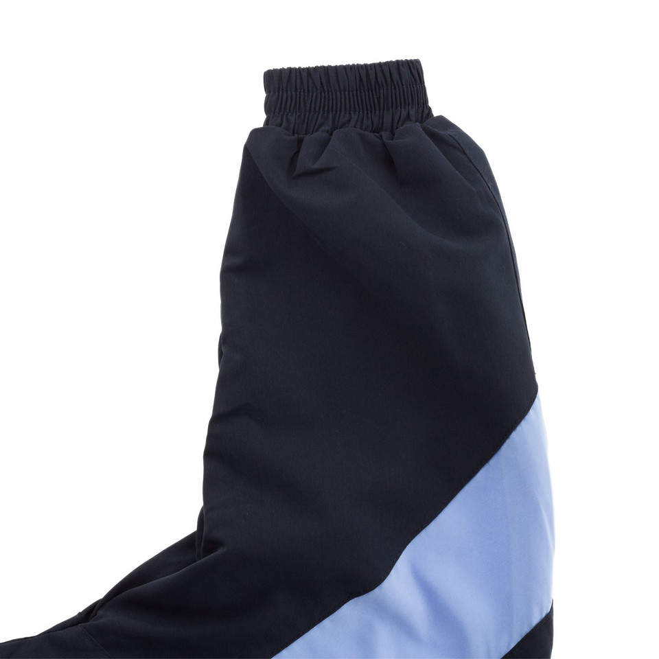 Close-up of navy microfibre sport jacket sleeve with powder blue diagonal contrast panel and ribbed cuff