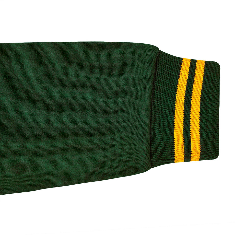 Close-up of forest green fleece bomber jacket sleeve with gold and dark green striped ribbed cuff
