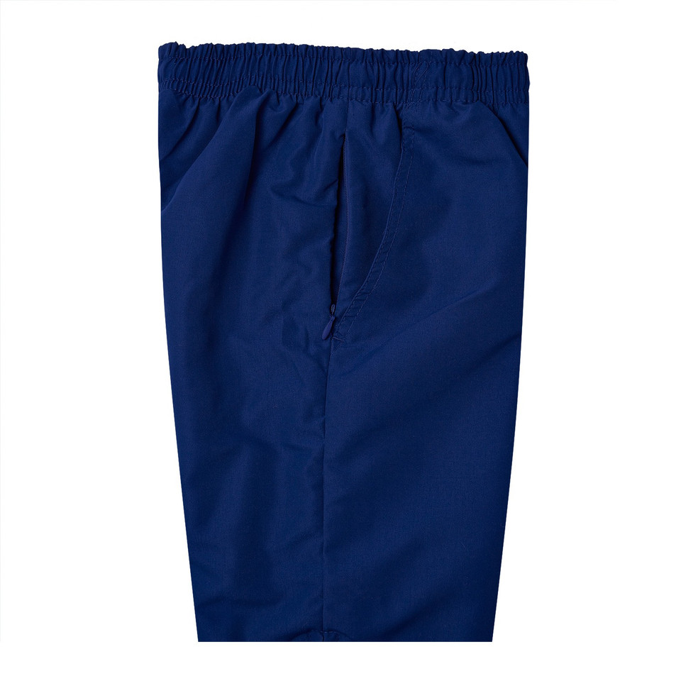 Navy blue microfibre baggy track pants with elasticated waistband and zip fly, flat lay packshot