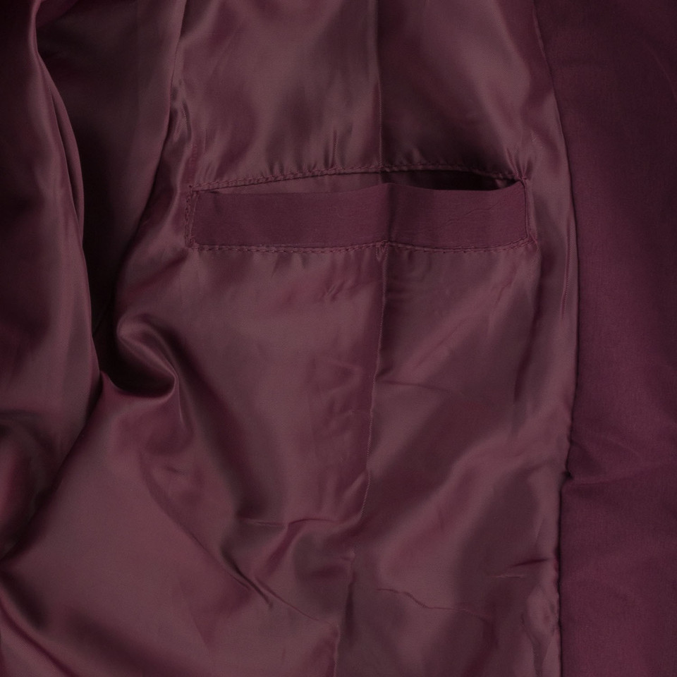 Close-up of deep burgundy microfibre jacket interior showing satin lining and inner chest pocket