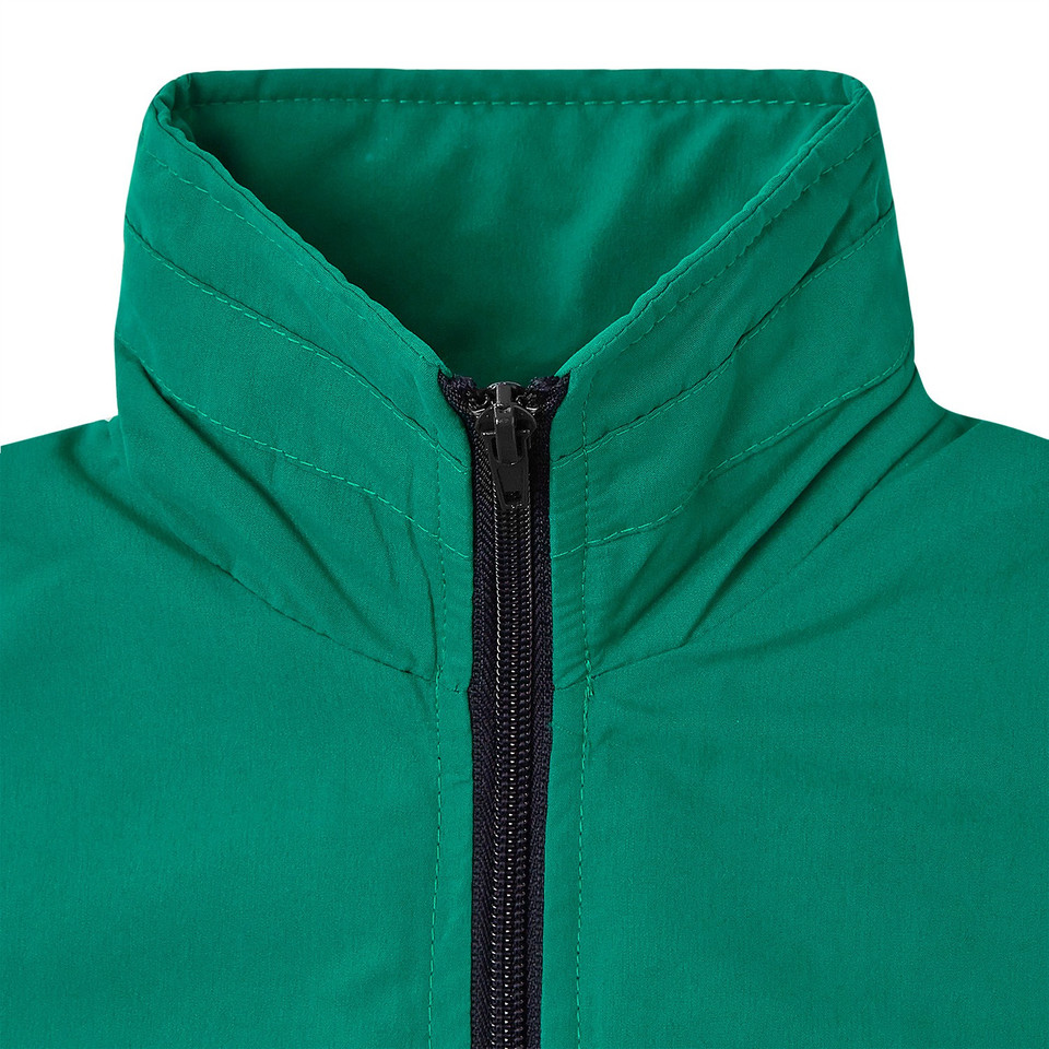 Close-up of emerald green kids jacket with stand collar and navy zip, quilted panelling detail