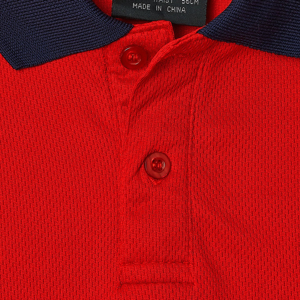 Red micro mesh kids polo with navy raglan collar and matching red buttons, close-up packshot