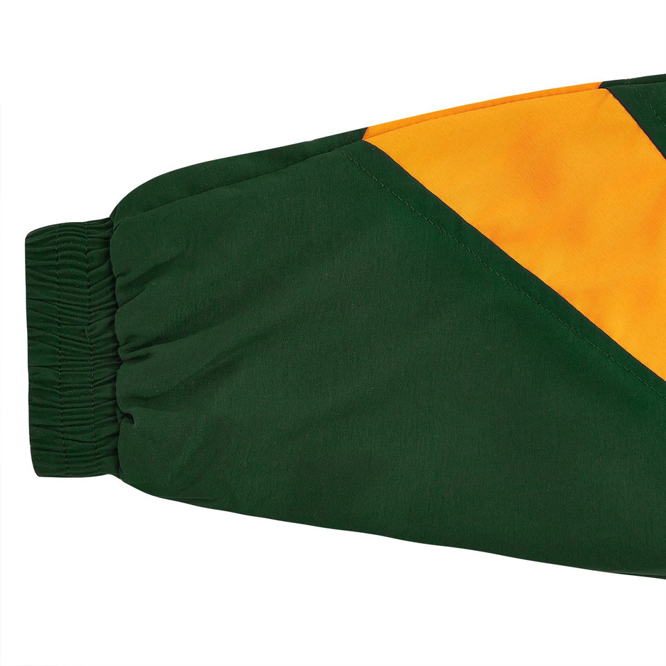 Close-up of bottle green and gold diagonal colour-block sleeve with ribbed elastic cuff on kids microfibre sport jacket