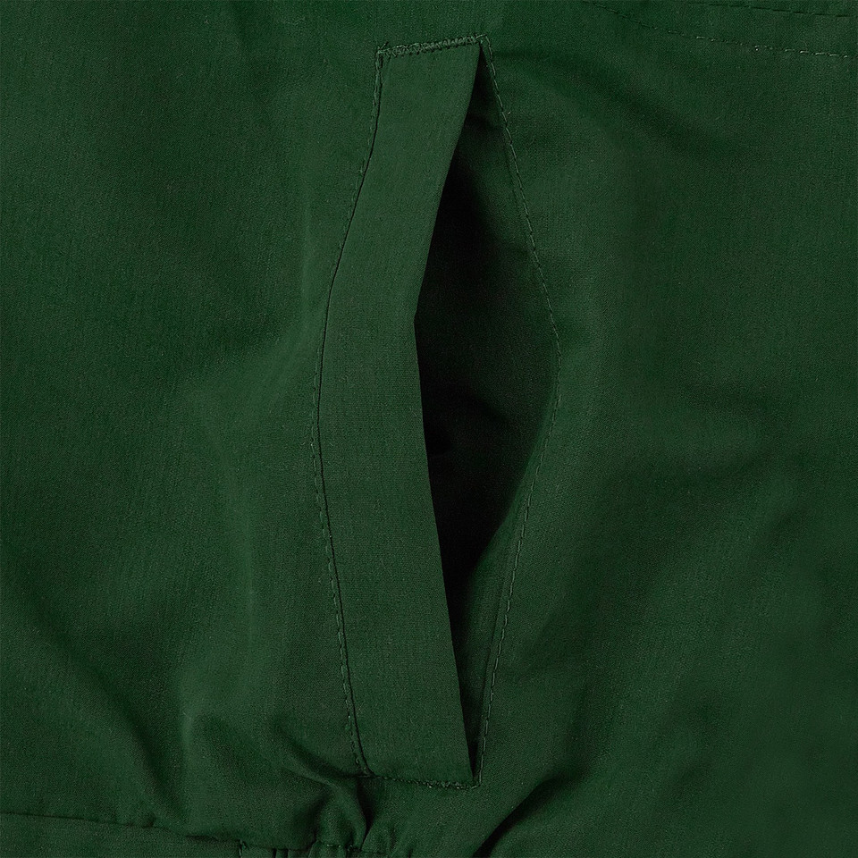 Close-up of bottle green microfibre jacket showing slash pocket with reinforced woven loop detail