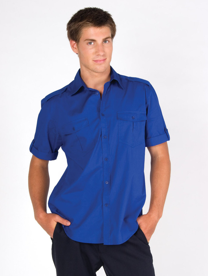 Male model wearing a royal blue short sleeve military shirt with twin chest pockets and epaulettes