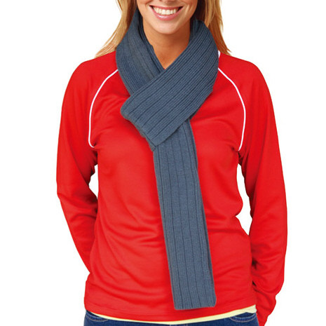 Cable knit scarf in denim blue with ribbed texture draped over red jacket with white piping