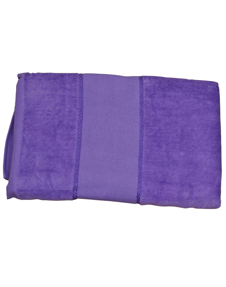 Folded violet cotton velour beach towel with smooth central band, packshot flat lay