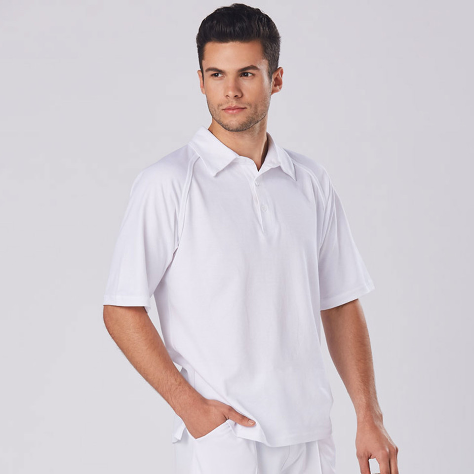 Man wearing white cricket polo shirt with short sleeves, side vents, and tonal button placket