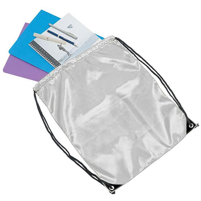 Silver drawstring backpack with black cords holding stationery items including folders and pens