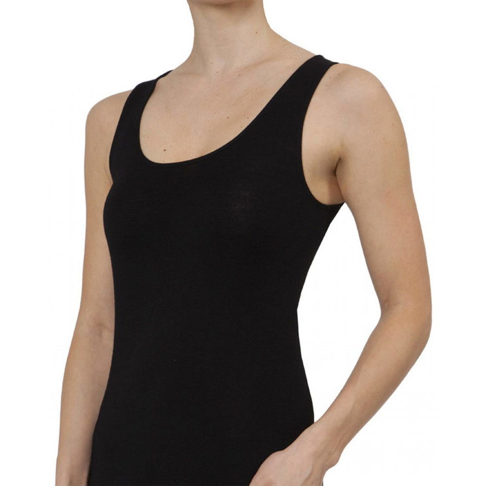Women's black merino wool vest with wide shoulder straps and scoop neckline, worn by model