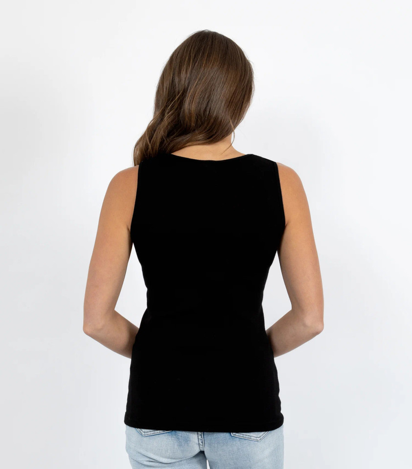 Rear view of a woman wearing a fitted black merino wool vest with a scoop back and clean shoulder straps