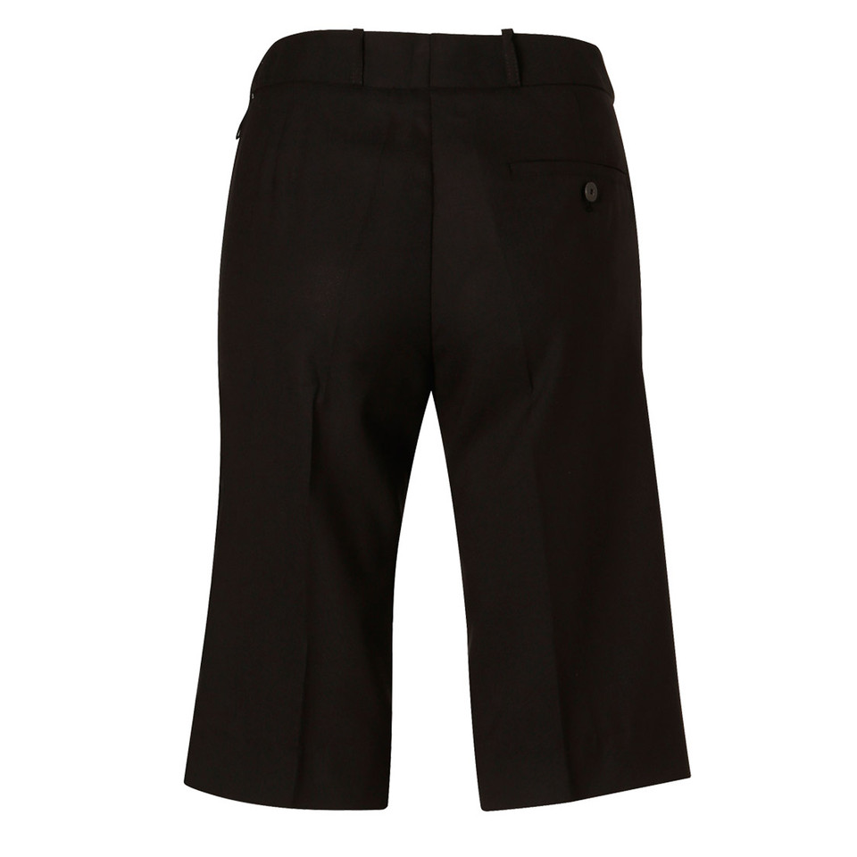 Black knee-length stretch shorts with belt loops and back pocket detail, rear view
