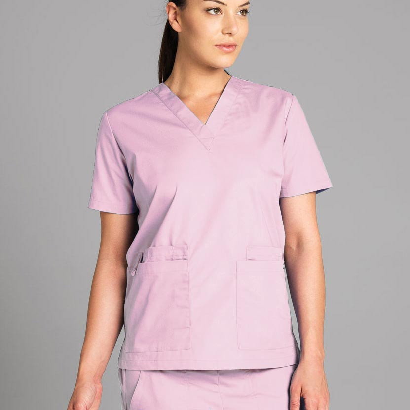 Woman wearing a dusty pink short-sleeve V-neck scrubs top with two front patch pockets