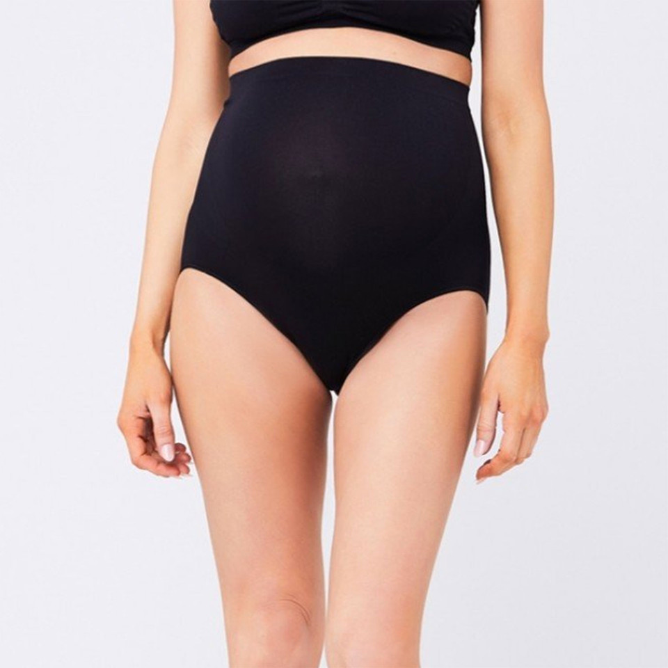 Model wearing black high-waisted seamless maternity briefs with smooth wide waistband panel