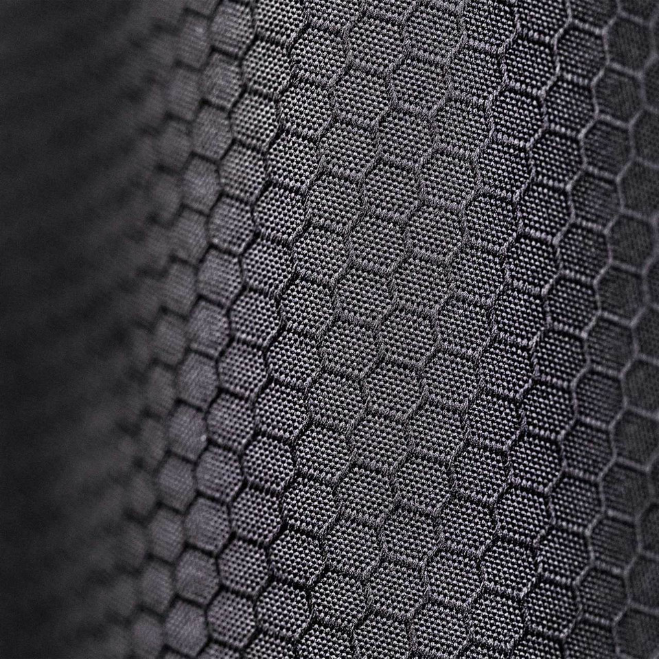 Close-up of charcoal hexagonal honeycomb thermal weave fabric on technical outer shell jacket