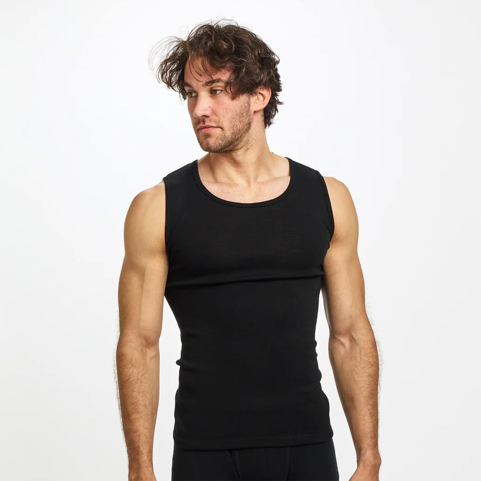 A plain black GETAWAY Men's Tank Singlet, made from 100% merino wool (200g/m2). The athletic thermal base layer is warm, soft, breathable, non-itchy, and ideal for travel or layering.