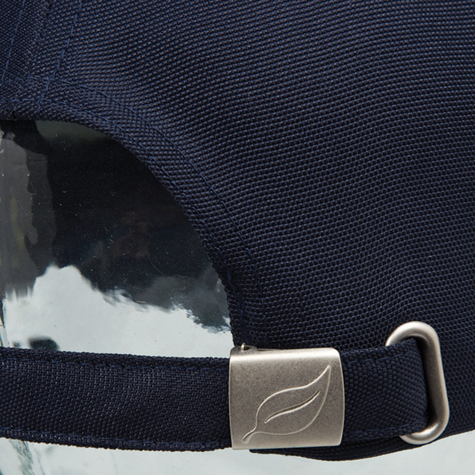 Close-up of navy recycled PET cap showing brushed silver leaf-embossed slider buckle and woven strap detail