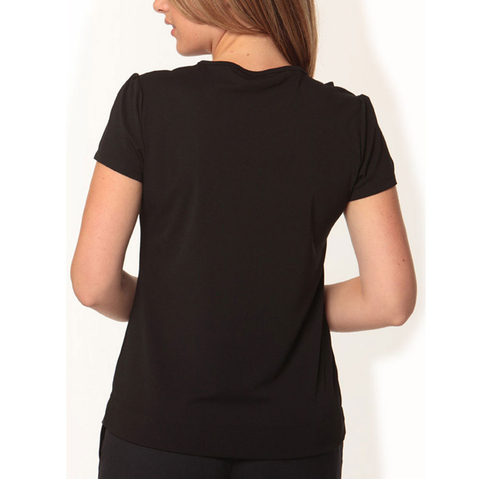 Back view of woman wearing black short sleeve top with subtle ruffle shoulder detail