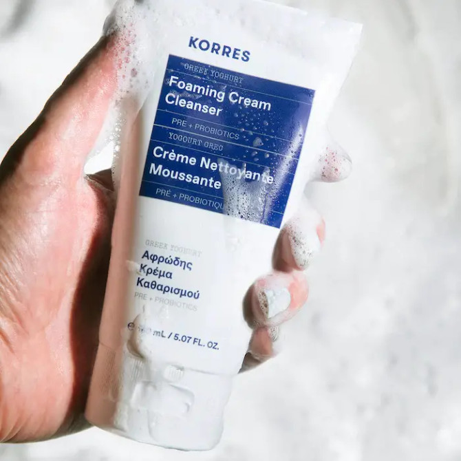 Korres Greek Yoghurt Foaming Cream Cleanser in a hand