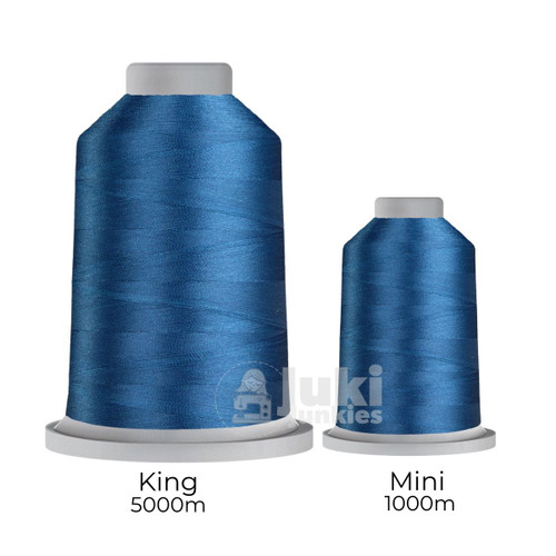 Close-up of two spools of Glide 40 weight polyester thread in Cosmic: a large King spool (5,500 yards) and a smaller Mini spool (1,100 yards), shown side by side for size comparison, with a smooth texture and noticeable sheen.
