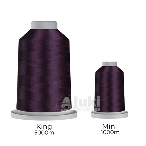 Close-up of two spools of Glide 40 weight polyester thread in Galaxy: a large King spool (5,500 yards) and a smaller Mini spool (1,100 yards), shown side by side for size comparison, with a smooth texture and noticeable sheen.