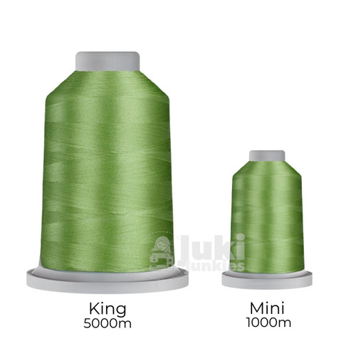 Close-up of two spools of Glide 40 weight polyester thread in Clover: a large King spool (5,500 yards) and a smaller Mini spool (1,100 yards), shown side by side for size comparison, with a smooth texture and noticeable sheen.