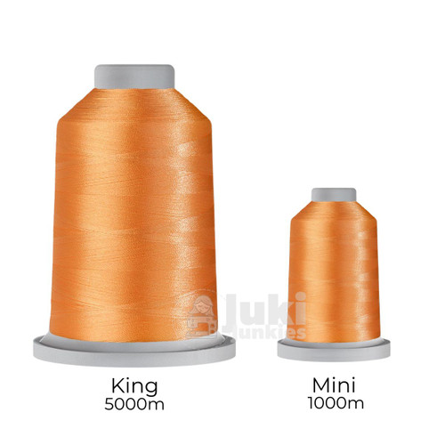 Close-up of two spools of Glide 40 weight polyester thread in Goldenlight: a large King spool (5,500 yards) and a smaller Mini spool (1,100 yards), shown side by side for size comparison, with a smooth texture and noticeable sheen.