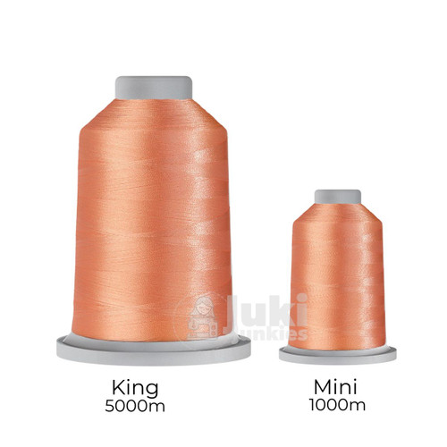 Close-up of two spools of Glide 40 weight polyester thread in Sunkissed Peach: a large King spool (5,500 yards) and a smaller Mini spool (1,100 yards), shown side by side for size comparison, with a smooth texture and noticeable sheen.