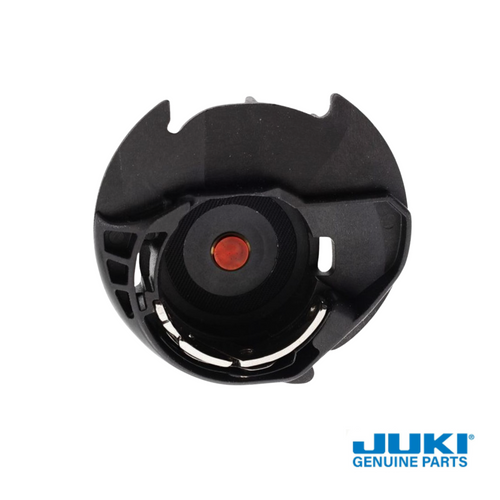 Close up of plastic low tension bobbin case for Juki computerized sewing machines.