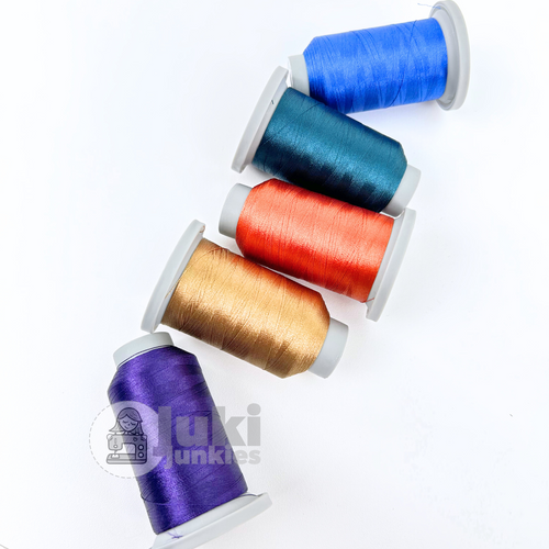 Set of five Glide 40wt mini thread spools in Concord, Reef, Burnt Orange, Blue Jay, and Vegas Gold, 1100-yard polyester threads made in the USA, perfect for sewing, quilting, embroidery, and bag making with a silky, lint-free finish
