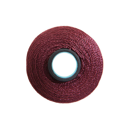 Close-up of a Glide 40 weight polyester thread bobbin in Maroon, size L, with 72 yards of thread.