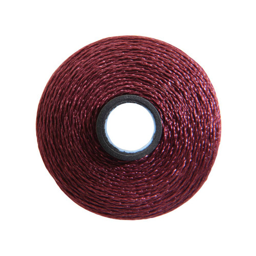Close-up of a Glide 40 weight polyester thread bobbin in Maroon, size M, with 132 yards of thread.