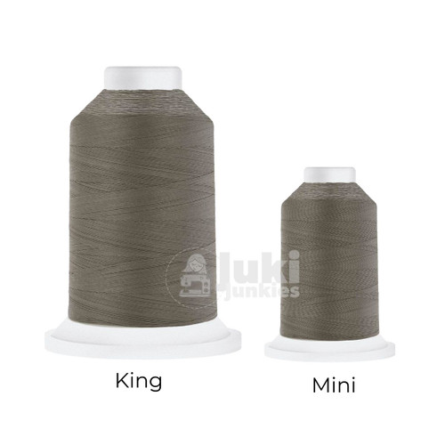 Close-up of two Cairo Quilt 50 weight Egyptian cotton thread spools in Cool Grey 7, showing a soft, matte finish. A large King spool (3,000 yards) and a smaller Mini spool (670 yards) are side by side for size comparison.
