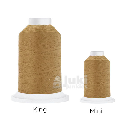 Close-up of two Cairo Quilt 50 weight Egyptian cotton thread spools in Military Gold, showing a soft, matte finish. A large King spool (3,000 yards) and a smaller Mini spool (670 yards) are side by side for size comparison.