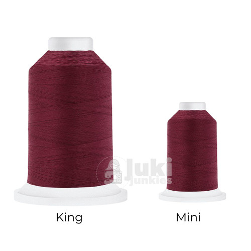 Close-up of two Cairo Quilt 50 weight Egyptian cotton thread spools in Maroon, showing a soft, matte finish. A large King spool (3,000 yards) and a smaller Mini spool (670 yards) are side by side for size comparison.