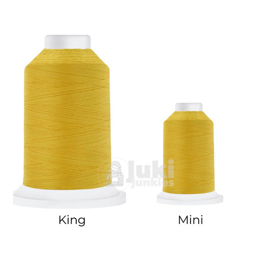 Close-up of two Cairo Quilt 50 weight Egyptian cotton thread spools in Bright Yellow, showing a soft, matte finish. A large King spool (3,000 yards) and a smaller Mini spool (670 yards) are side by side for size comparison.