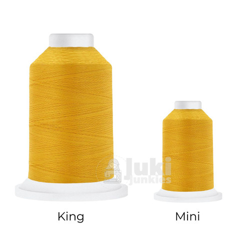Close-up of two Cairo Quilt 50 weight Egyptian cotton thread spools in Mango, showing a soft, matte finish. A large King spool (3,000 yards) and a smaller Mini spool (670 yards) are side by side for size comparison.