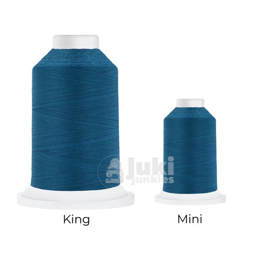 Close-up of two Cairo Quilt 50 weight Egyptian cotton thread spools in Pacific, showing a soft, matte finish. A large King spool (3,000 yards) and a smaller Mini spool (670 yards) are side by side for size comparison.