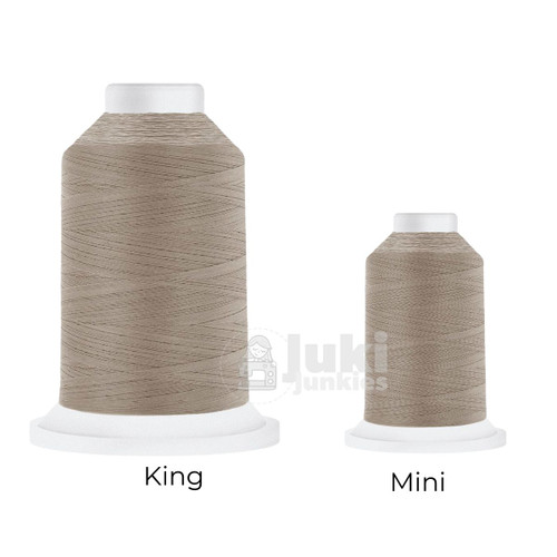 Close-up of two Cairo Quilt 50 weight Egyptian cotton thread spools in Cool Grey, showing a soft, matte finish. A large King spool (3,000 yards) and a smaller Mini spool (670 yards) are side by side for size comparison.
