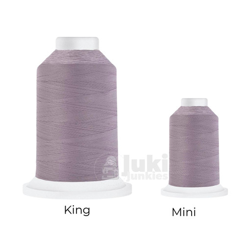 Close-up of two Cairo Quilt 50 weight Egyptian cotton thread spools in Tabriz Orchid, showing a soft, matte finish. A large King spool (3,000 yards) and a smaller Mini spool (670 yards) are side by side for size comparison.