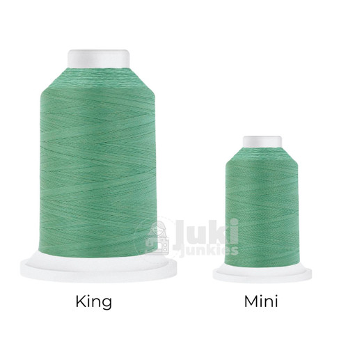 Close-up of two Cairo Quilt 50 weight Egyptian cotton thread spools in Mint, showing a soft, matte finish. A large King spool (3,000 yards) and a smaller Mini spool (670 yards) are side by side for size comparison.
