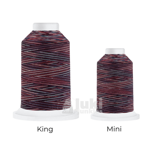 Close-up of a 500-yard spool of Harmony 40 weight variegated thread in shades of red, white, and blue, highlighting the color variations and matte finish.