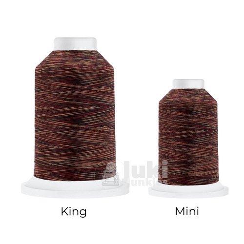Close-up of a 500-yard spool of Harmony 40 weight variegated thread in shades of red, brown, and cream, highlighting the color variations and matte finish.