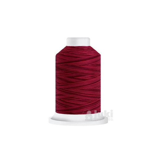 Close-up of a 500-yard spool of Harmony 40 weight variegated thread in shades of red, highlighting the color variations and matte finish.