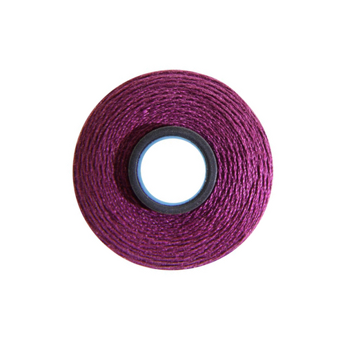Close-up of a Magna-Quilt 50 weight cotton bobbin, size L, in Violet, with 74 yards of thread.