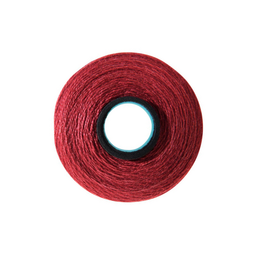 Close-up of a Magna-Quilt 50 weight cotton bobbin, size L, in Candy Apple, with 74 yards of thread.
