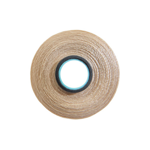 Close-up of a Glide 60 weight polyester bobbin in Light Tan, size L, with 130 yards of fine thread.