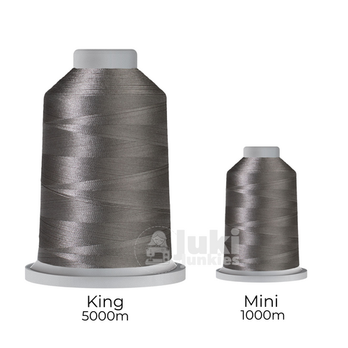Close-up of two spools of Glide 40 weight polyester thread in Steel: a large King spool (5,500 yards) and a smaller Mini spool (1,100 yards), shown side by side for size comparison, with a smooth texture and noticeable sheen.